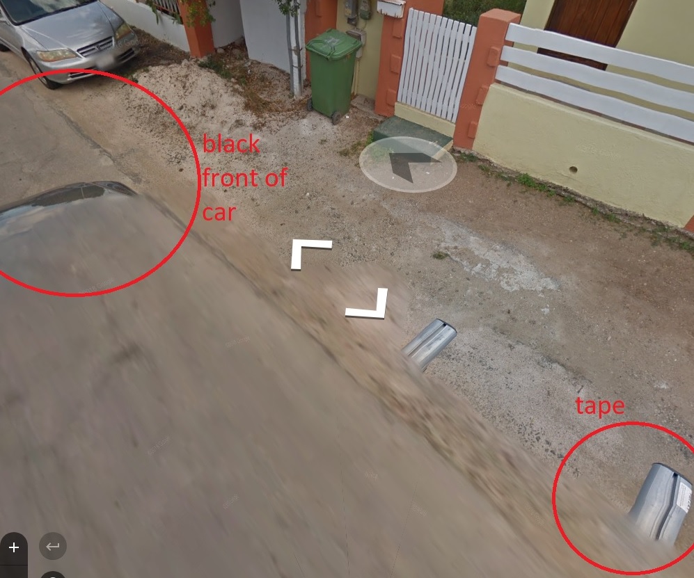 Black front of car and white tape on Curacao car.